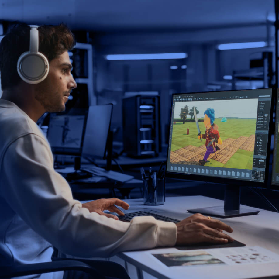 Person with headphones working on a computer