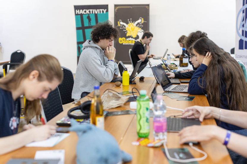 MetaDefender Sandbox Team presents groundbreaking research at a conference, team members working on laptops