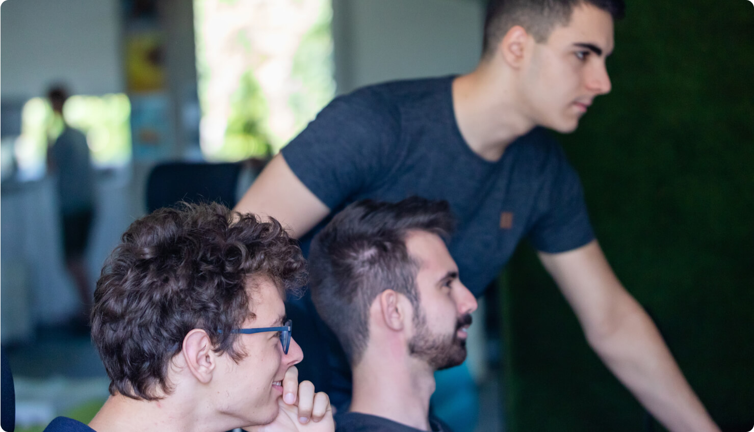 domonkos, adrian, and andras standing together and looking at something off camera