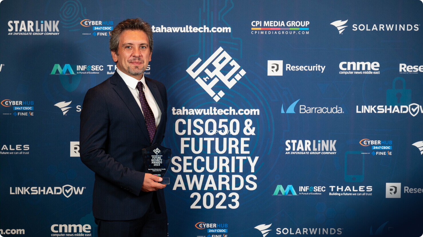 opswat team member holding an aware and standing in front of a banner reading - ciso 50 & future security awards 2023