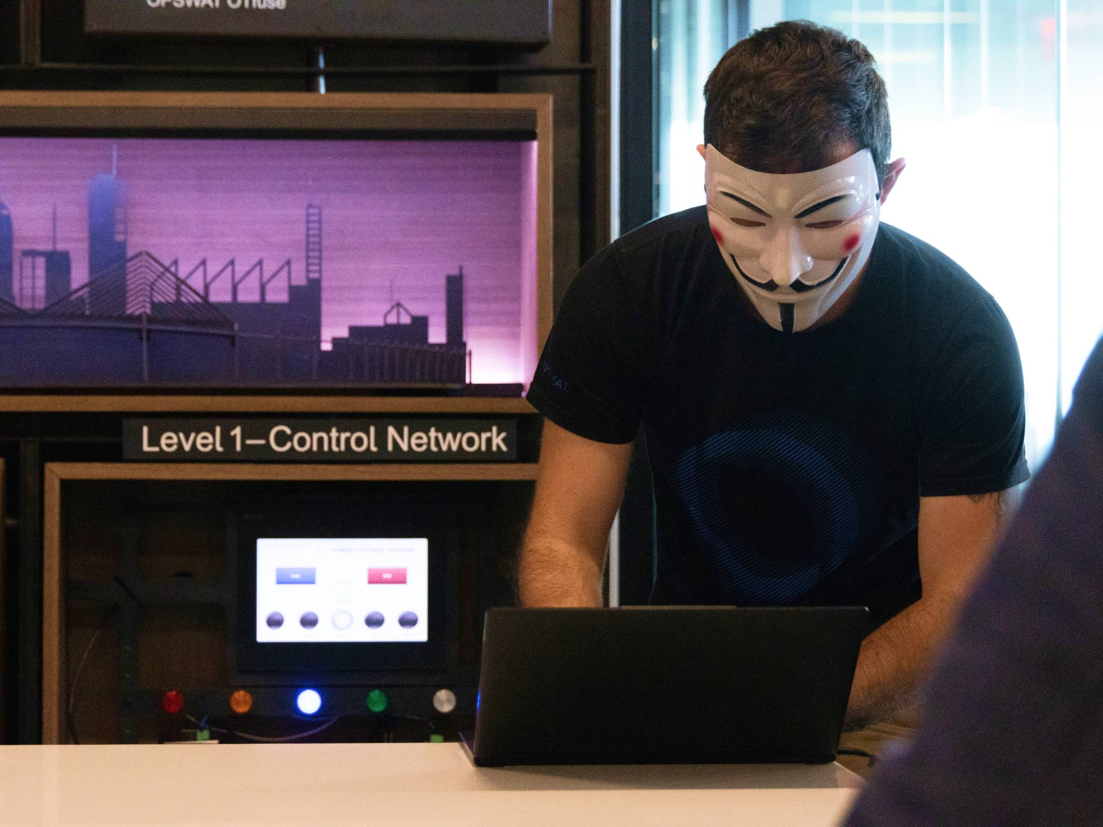 متظاهر يرتدي قناع القرصنة في مختبرات OPSWAT يسلط الضوء على أهمية الأمن السيبراني لشبكات التحكم من المستوى الأول