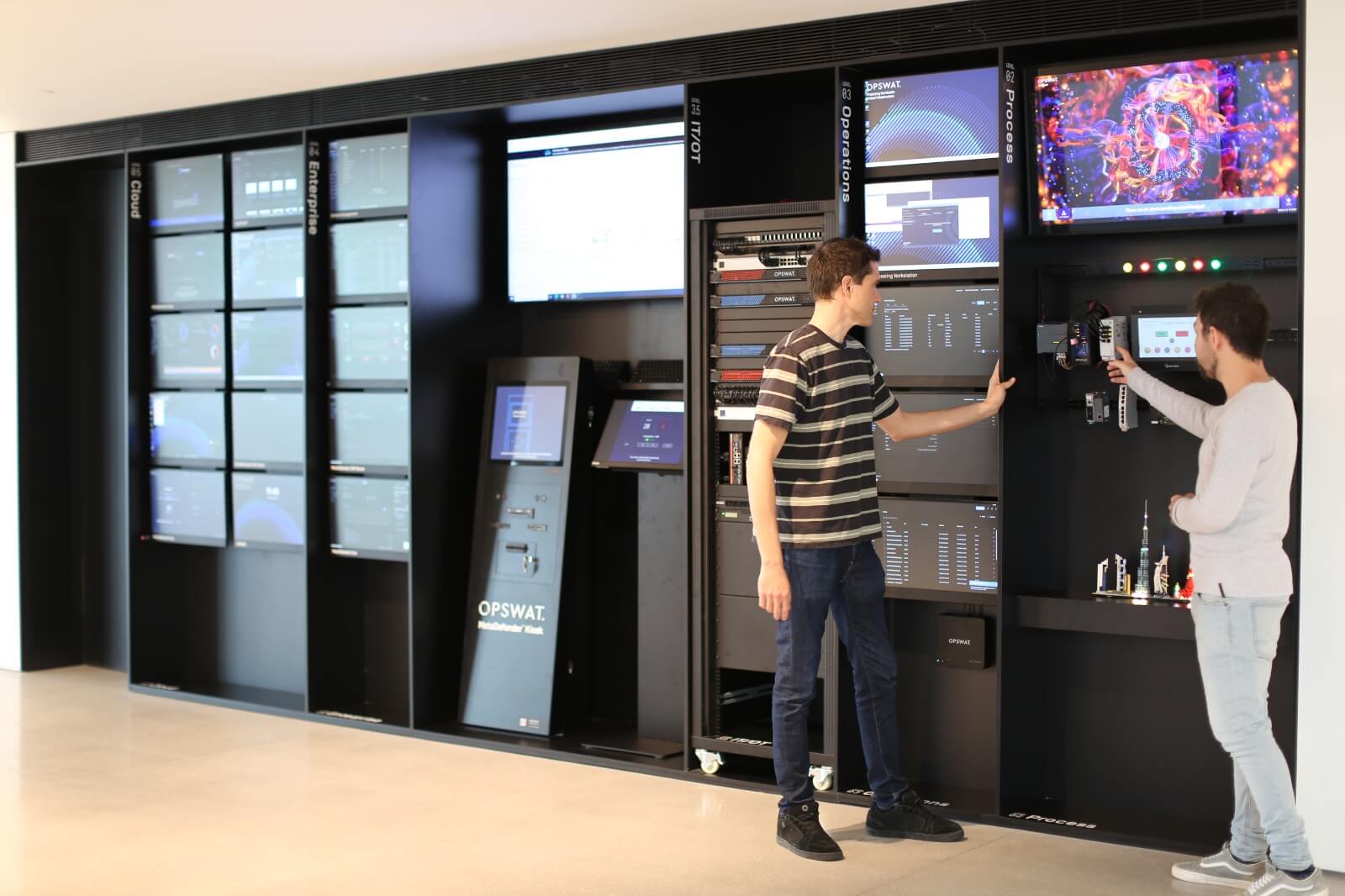 two people interacting with cybersecurity equipment at an OPSWAT cyber lab