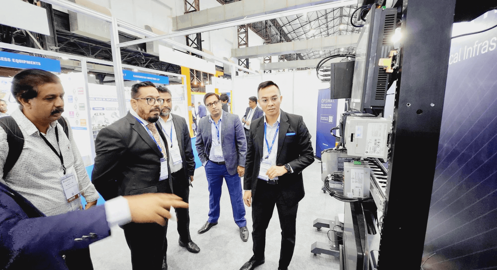 Men watching OPSWAT experts demonstrate IT and OT cybersecurity solutions in our CIP lab