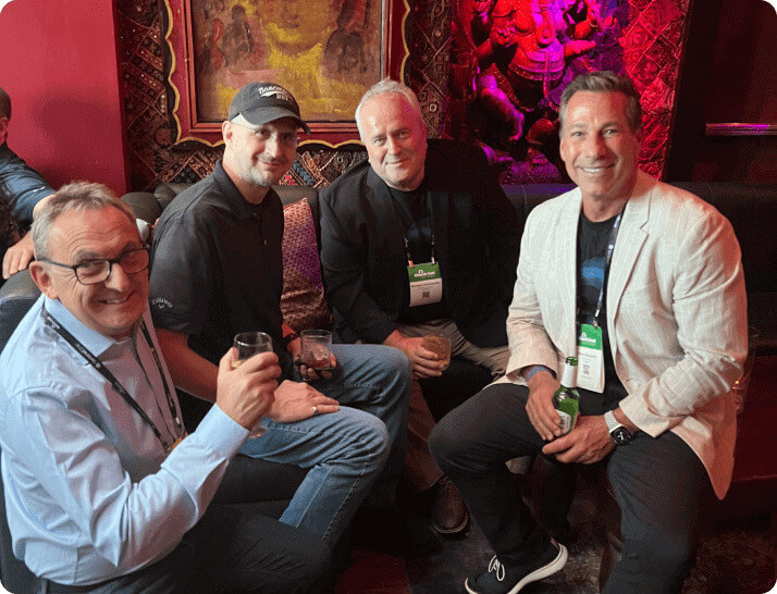 four gentlemen sitting on a couch at the opswat and inquest vip party