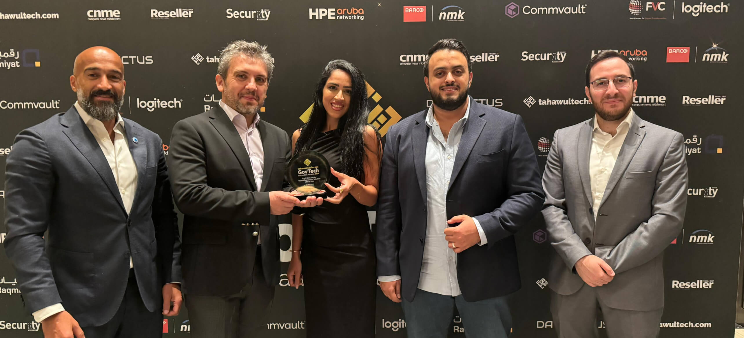 OPSWAT team members holding an award at a formal event