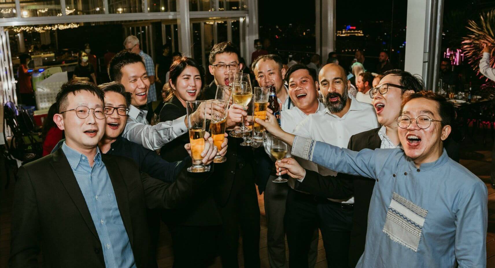 group of opswat employees holding drinks together and cheering