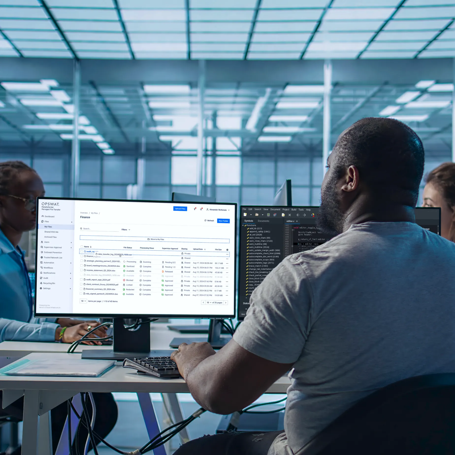 IT professionals monitor secure managed file transfer dashboard, reflecting ebook theme of redefining resilience