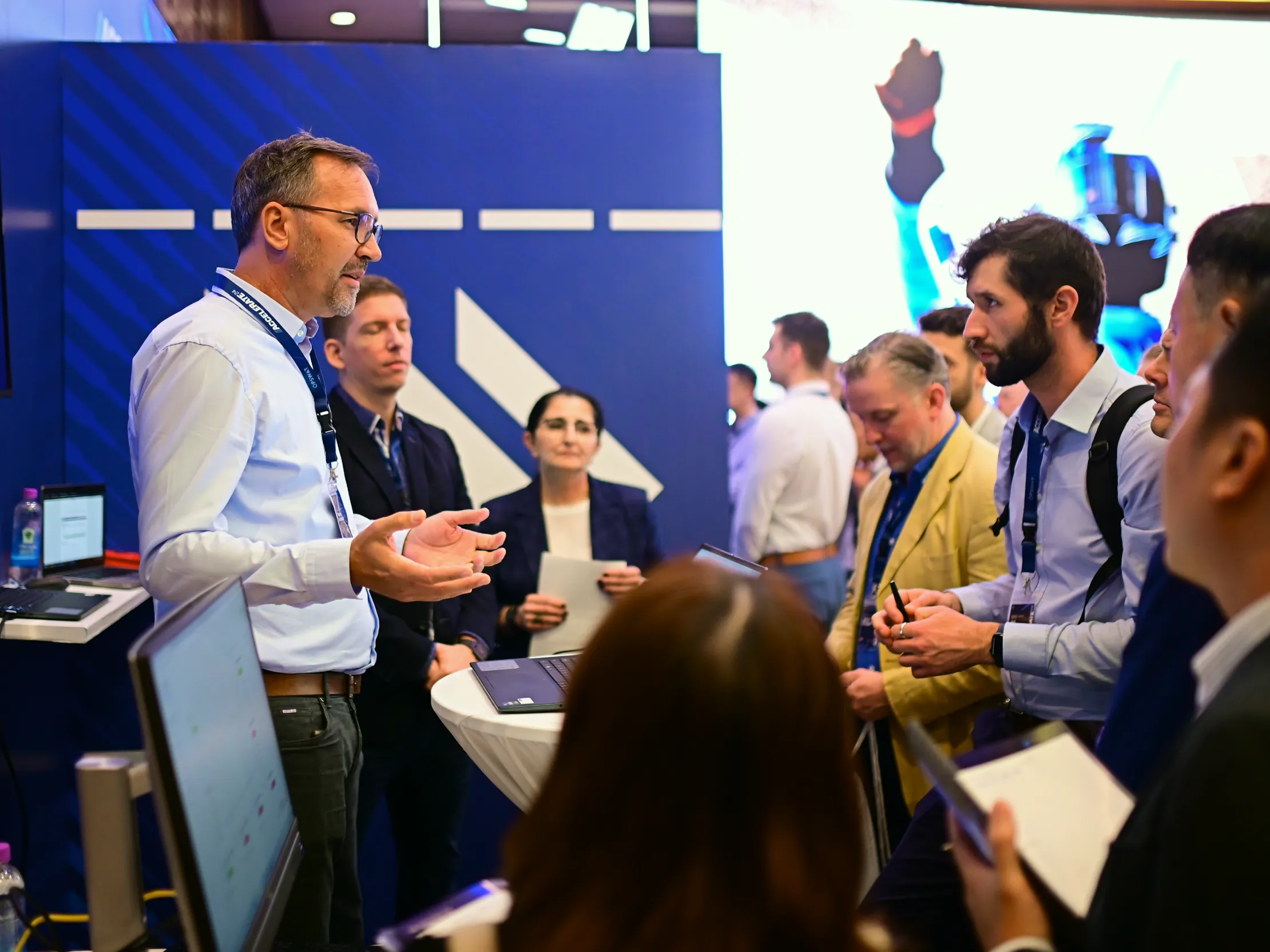 Group of professionals discussing cybersecurity at event booth