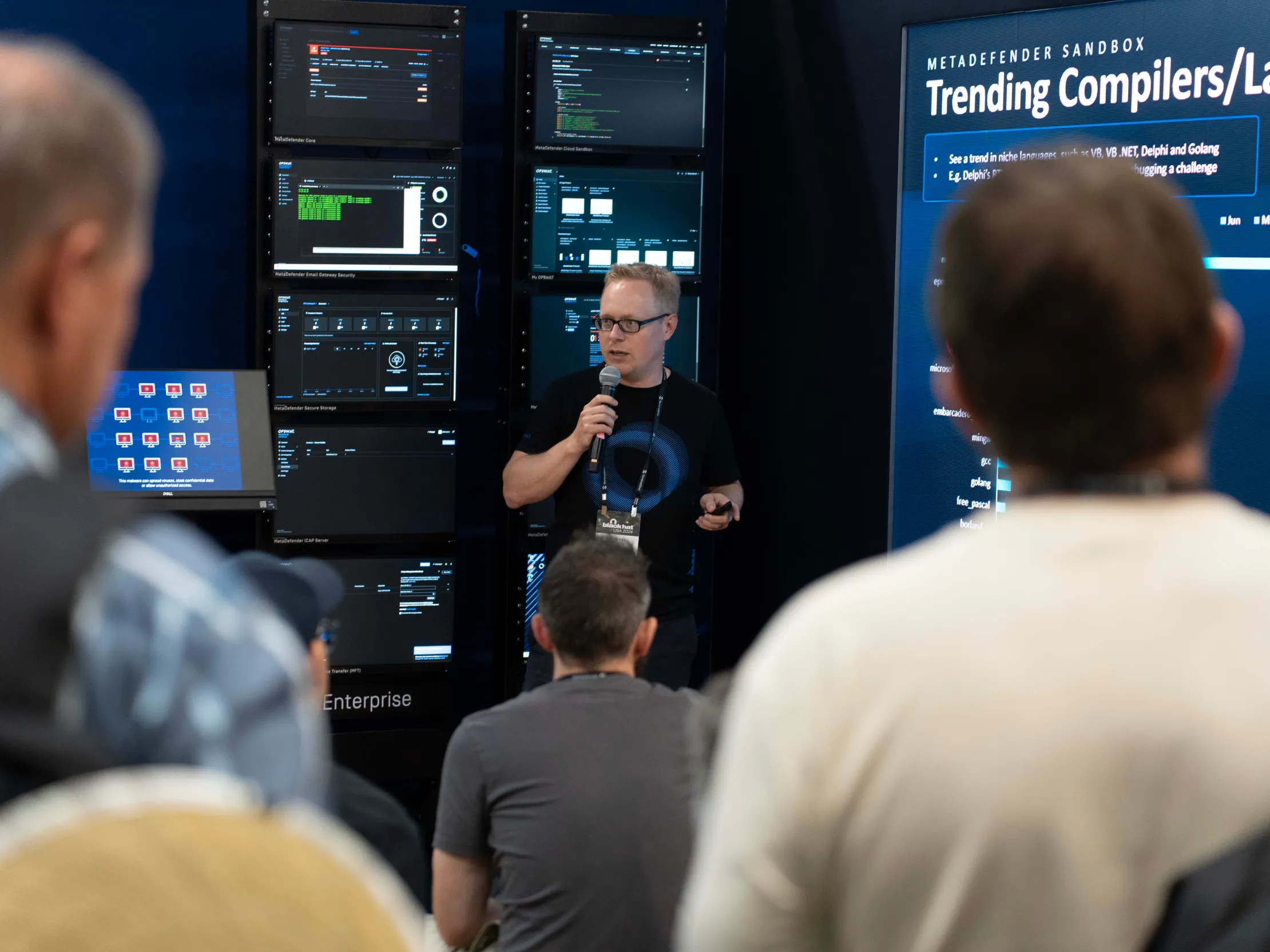OPSWAT speaker presenting cybersecurity dashboards and trending compilers
