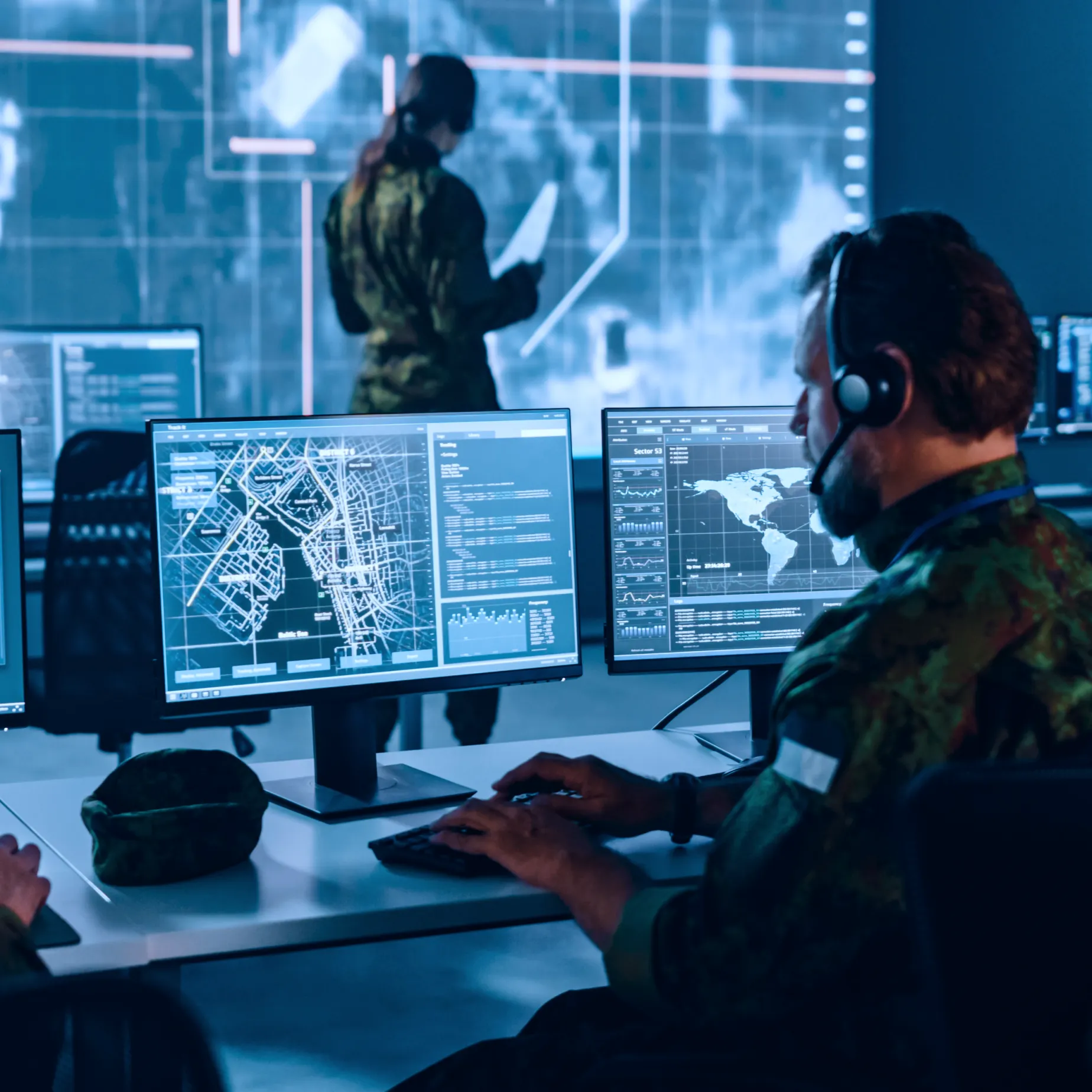 Military personnel at computers analyzing maps and data for cross domain solutions buyer's guide for government and defense security