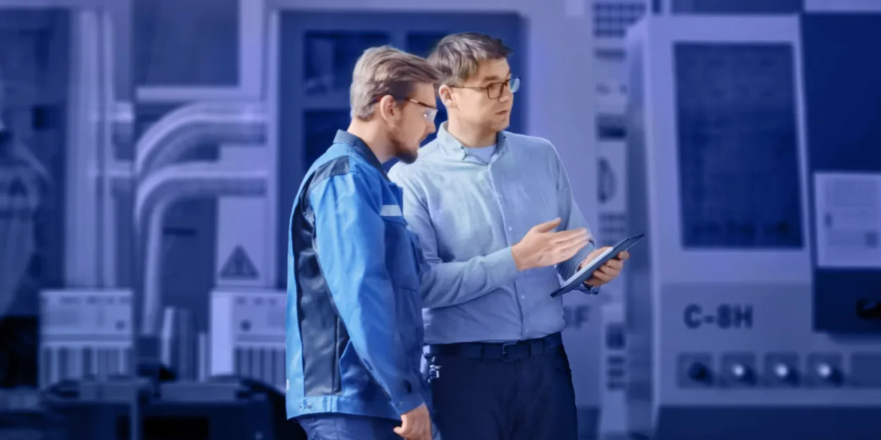 Two professionals discuss securing classified data with cross domain solutions in a high-tech facility