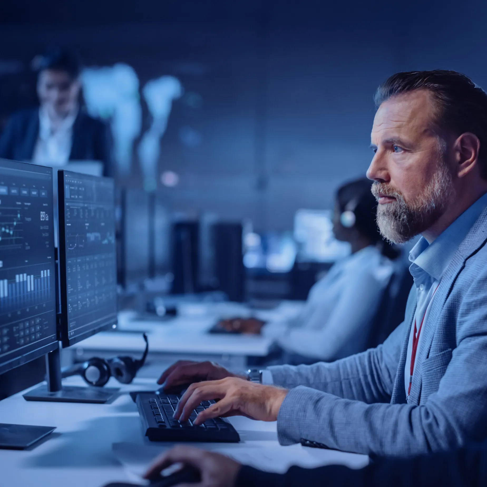 Un analyste en cybersécurité surveille des données sur des écrans, illustrant la nouvelle génération de bacs à sable en action.